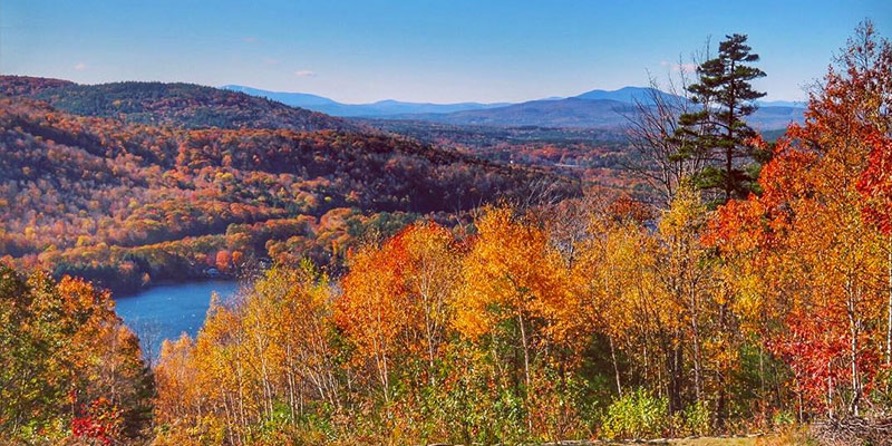 Lake Sunapee Scenic Byway Summit with orange yellow and green foliage