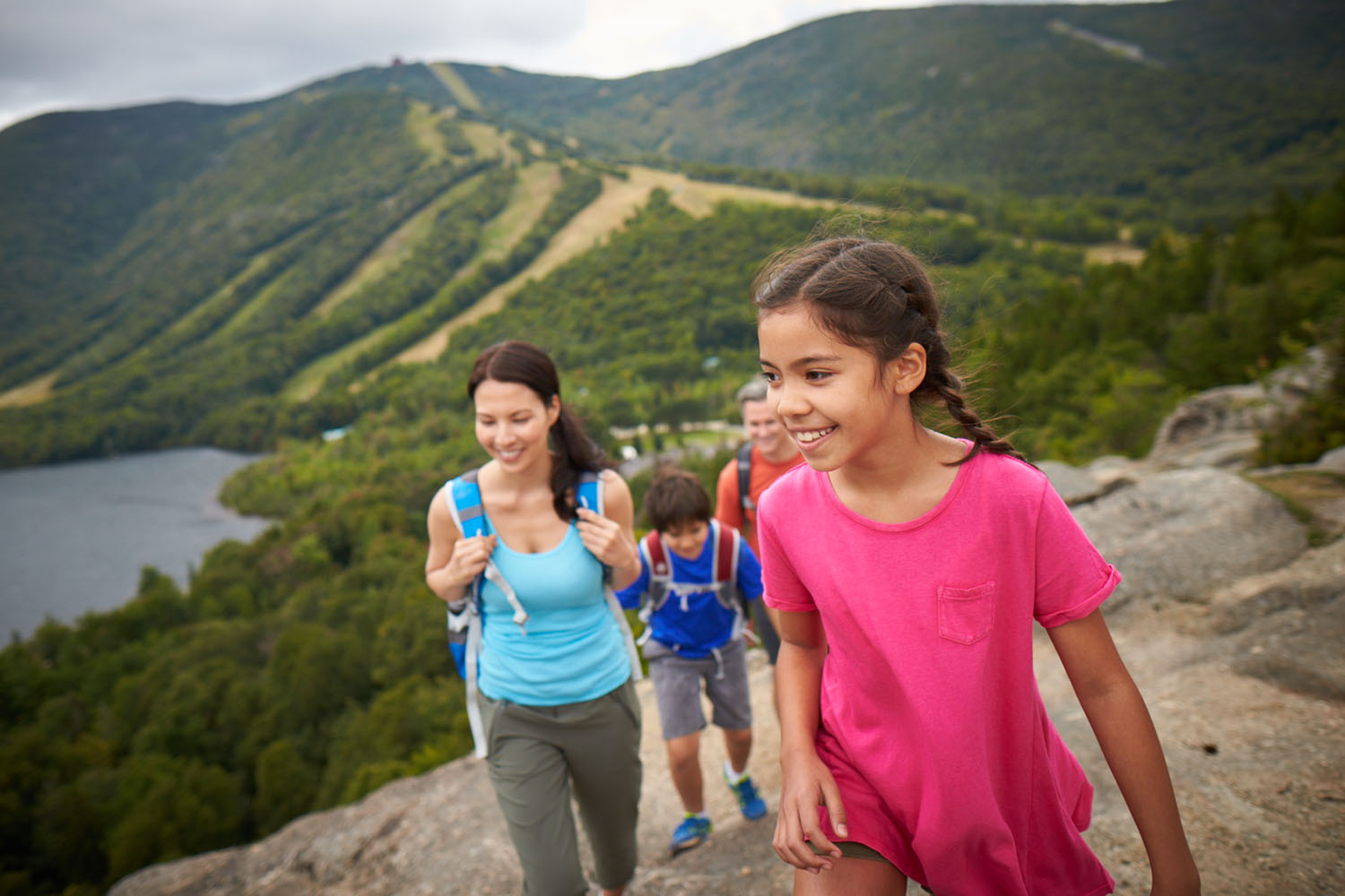 family with kids hiking a mountain