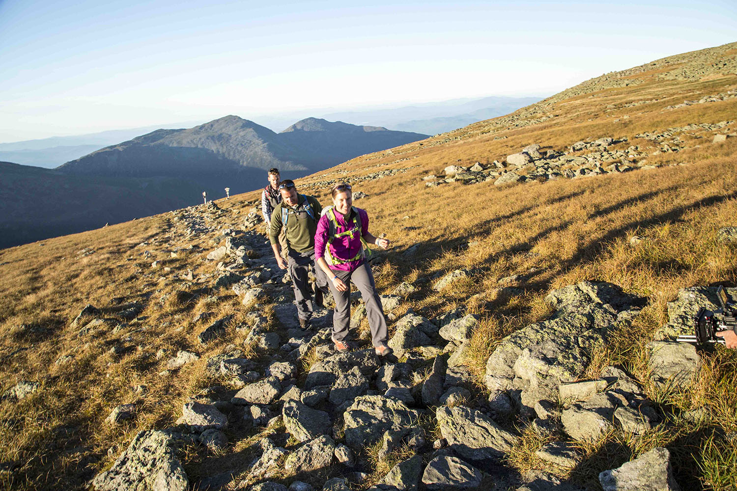 Group of people hiking up a rocky path