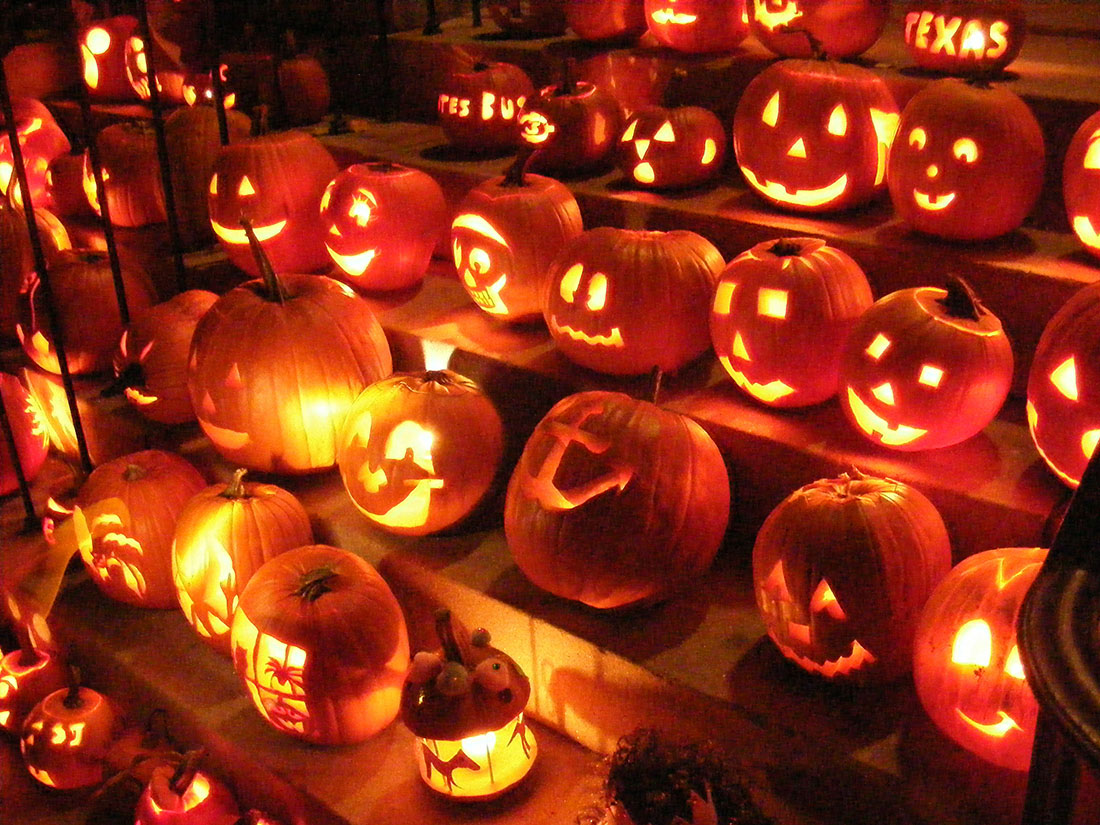 lit up jack o'lanterns together on steps