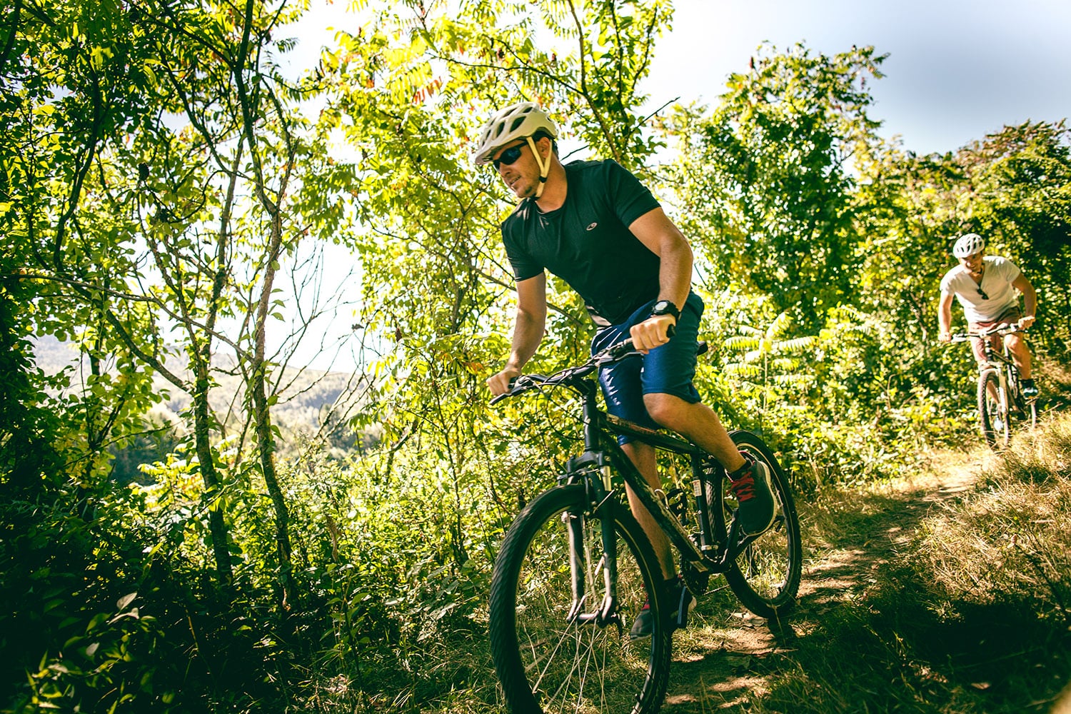 man mountain biking in the woods